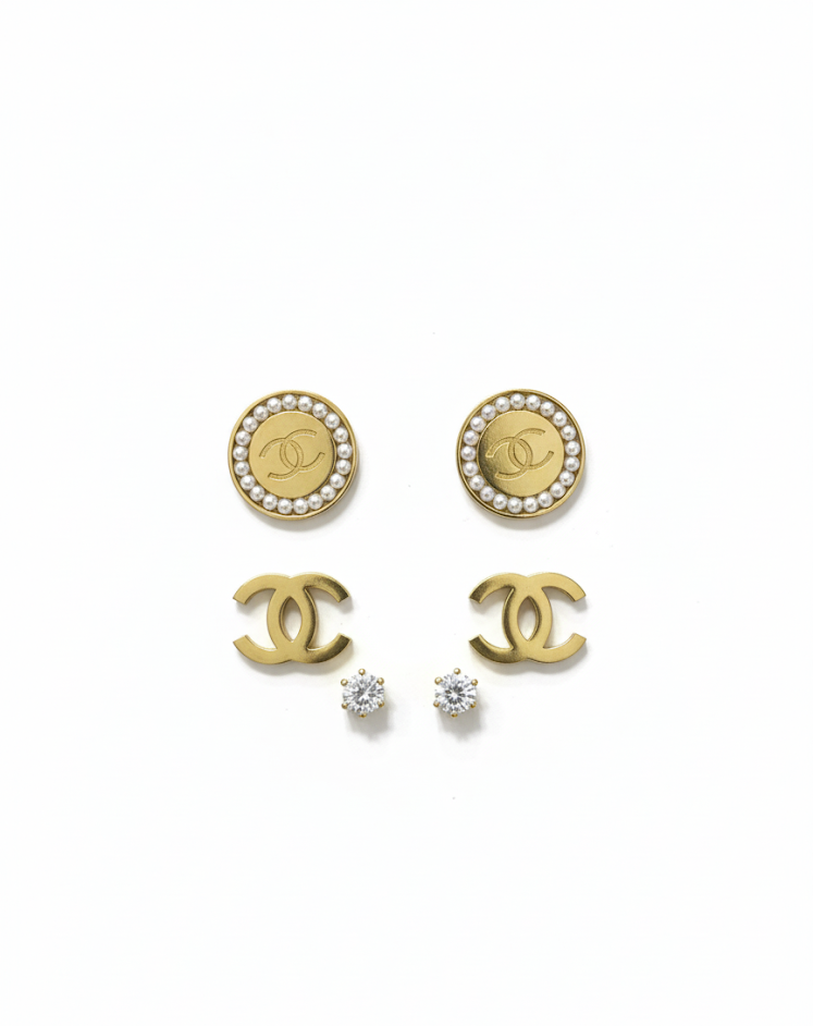 Chanel earrings with gold and pearl design on a white background